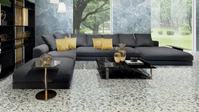 Pavimento variegato e mobili in tinta unita per il living, secondo Versace Ceramics
