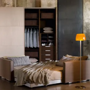 Camera da letto in stile essenziale con letto, lampada e armadio ad ante scorrevoli