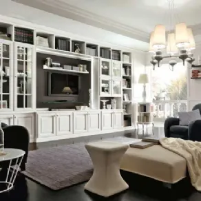 spazio living con scaffalatura bianca, vetrine e spazio tv, poltrone nere, puof e lampadario con paralumi