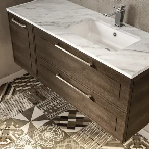 Piano in marmo e lavabo ad incasso in ceramica per questa elegante soluzione proposta dalla collezione Dressy