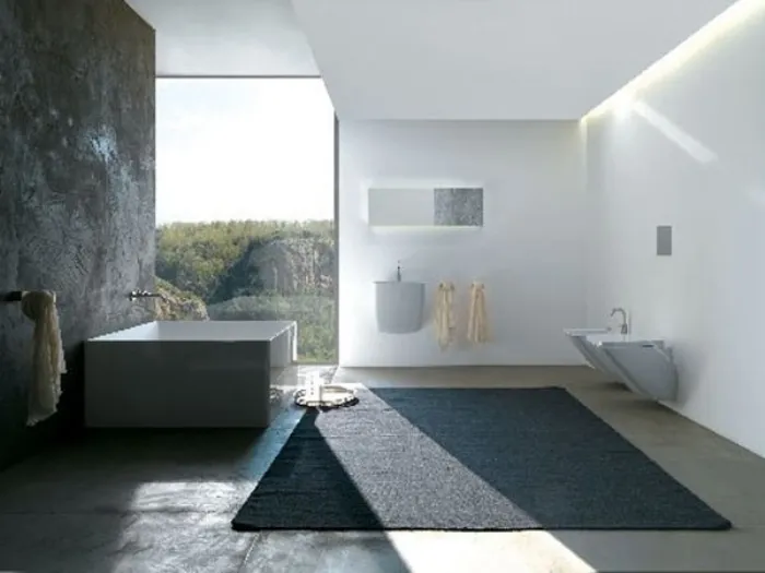 bagno con tappeto antracite, parete finestrata, vasca quadrangolare, parete scura