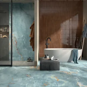 Collezione The Room di Imola Ceramica, in cui l'effetto marmo onice è abbinato al brick marrone lucido